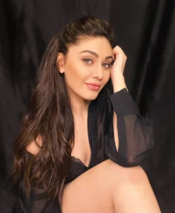 Shefali Jariwala smiling on the set of a reality show, radiating charm and grace.